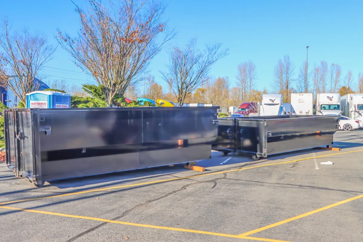 Professional dumpster rental service with roll-off container on residential driveway in Oak Grove